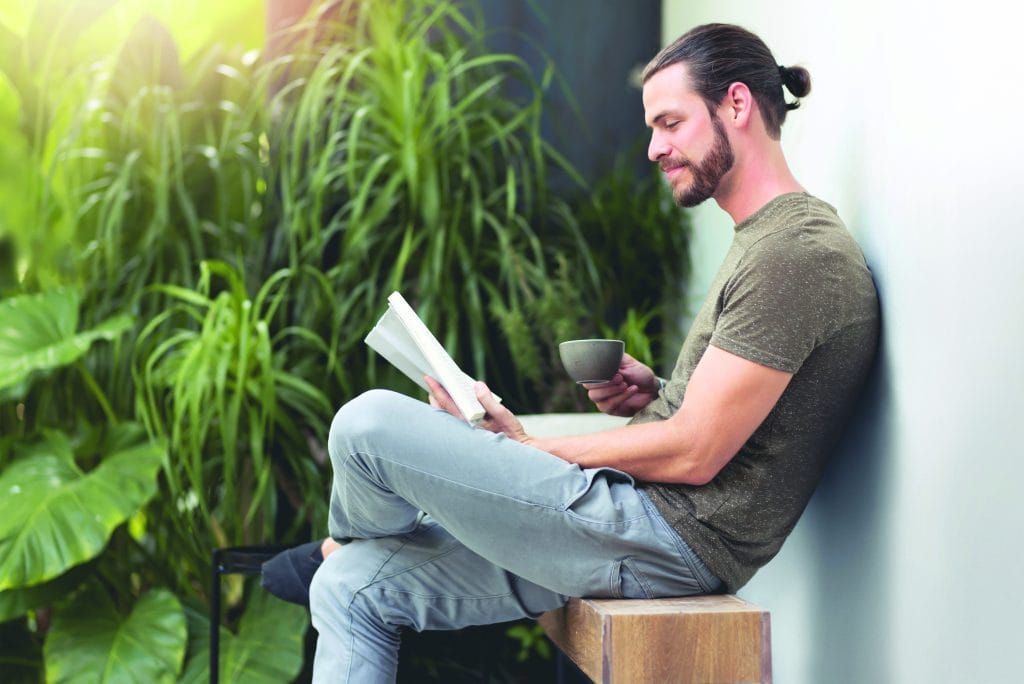 Relaxing Hipster man reading a book. What is a Sankalpa