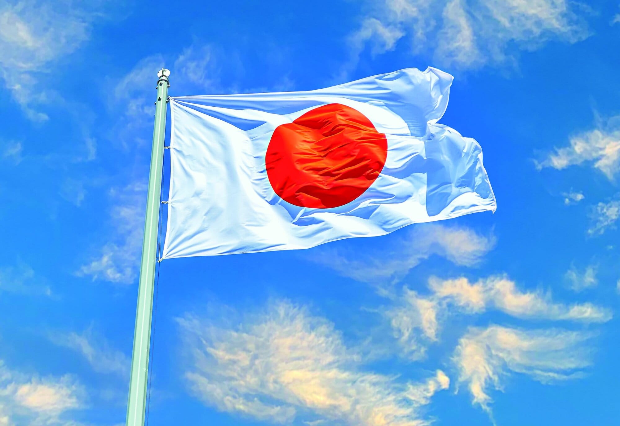 Japanese state flag waving on the wind against the sky