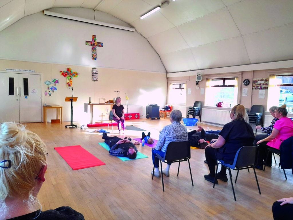 Upward Frog's CEO Emma Gartside teaches a mixed mat and chair yoga class at St. Luke's Church in Brinnington, Stockport