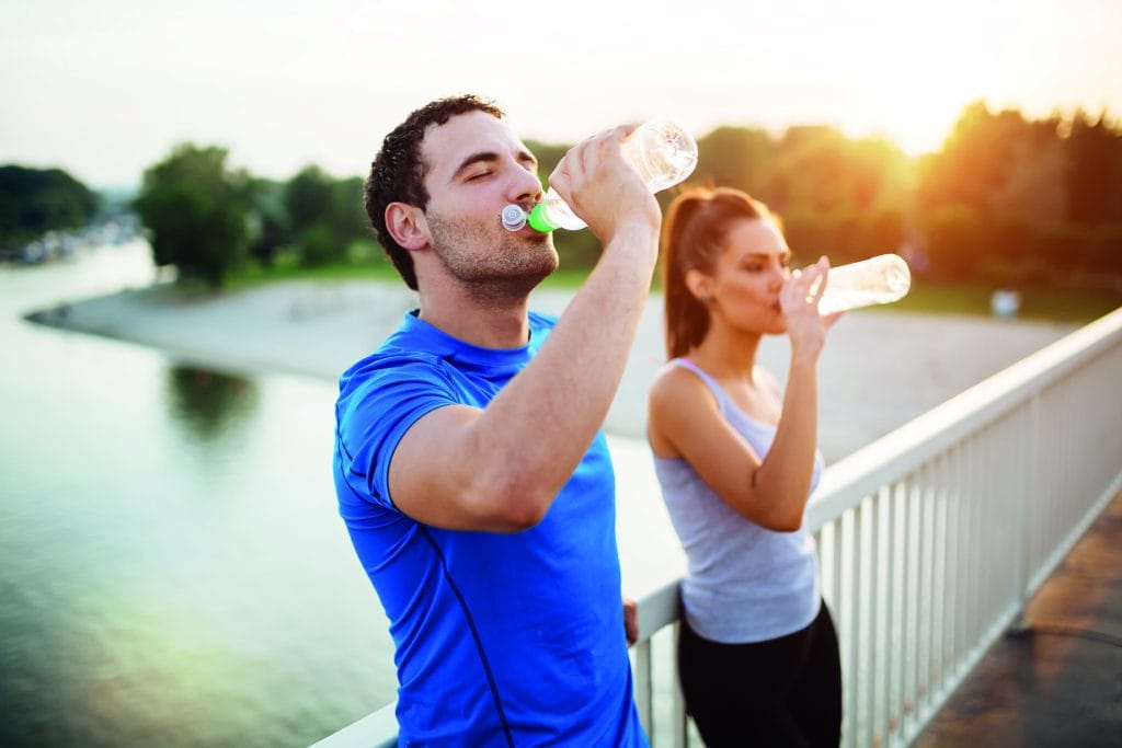 Couple staying hydrated Couple staying hydrated after workout