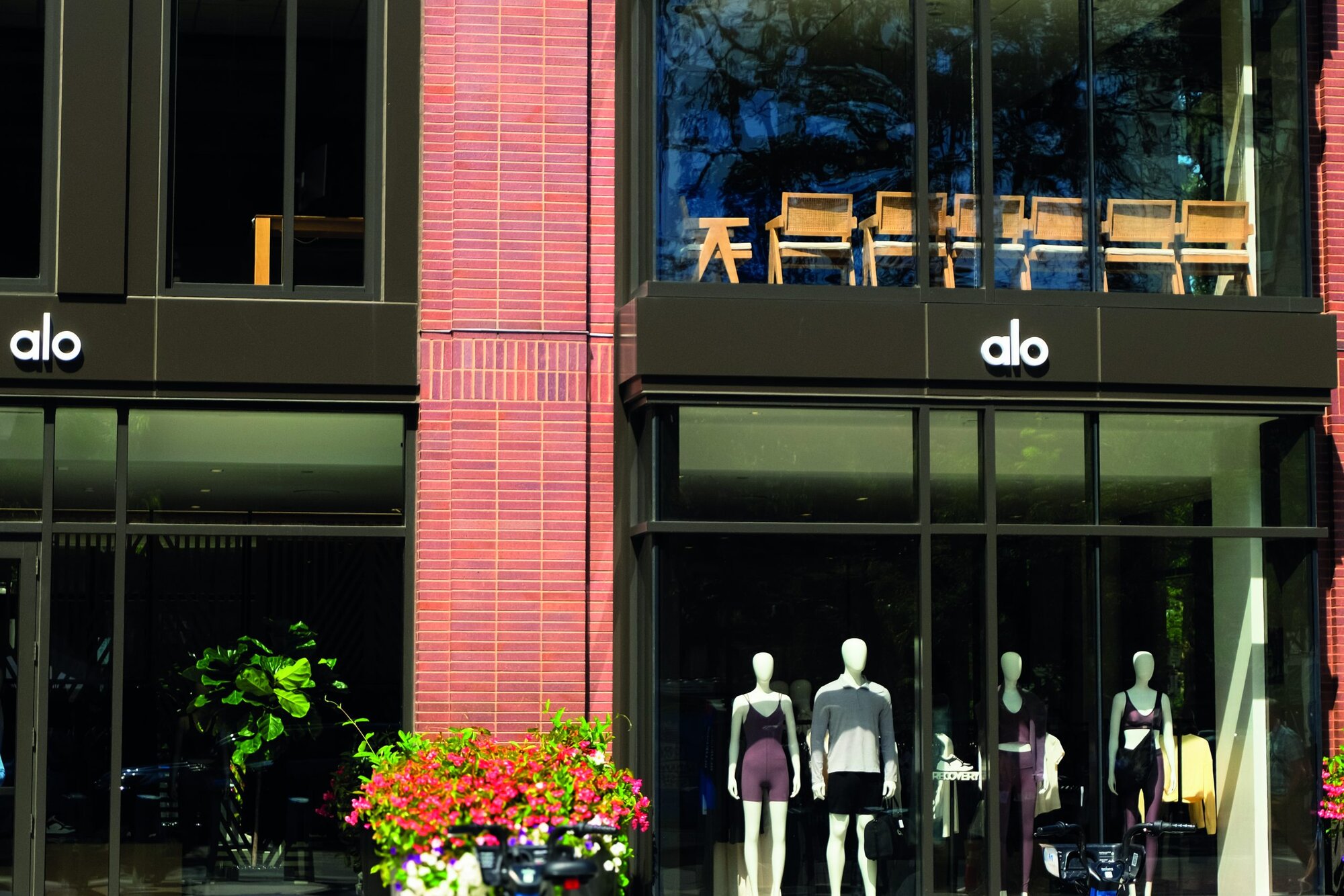 Boston, USA - 2 September 2024. General view of alo yoga logo sign and showcases on a store building facade