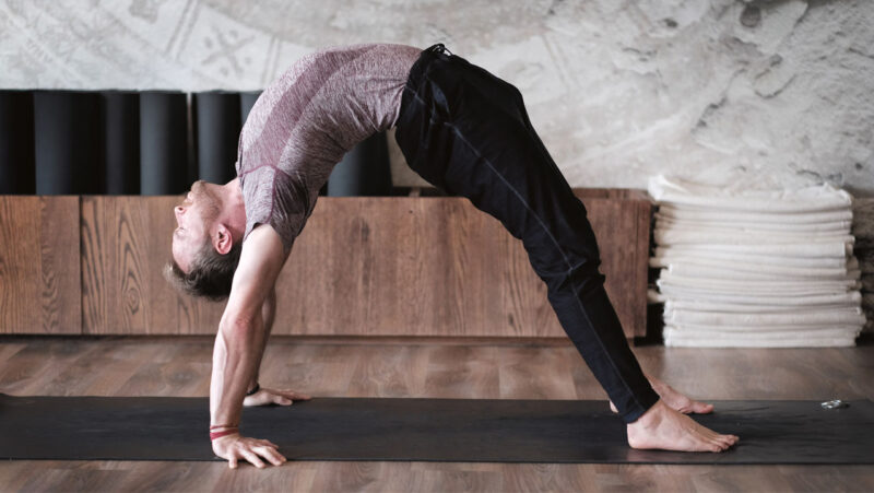 Davin Jones - man on the mat - full wheel pose