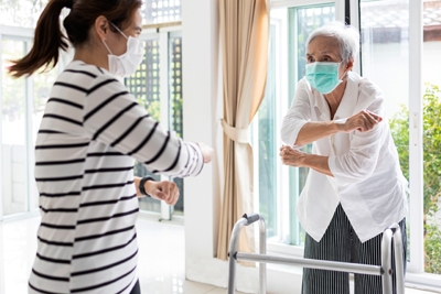 Asian woman is doing exercise activities for the elderly,senior mother,daughter workout to reduce stress,stay home during the pandemic of Covid-19,Coronavirus,fitness workout for health care from home