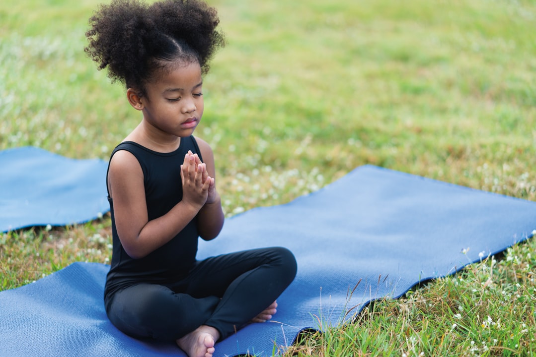 African,American,Little,Girl,Sitting,On,The,Roll,Mat,Practicing ways to help children understand relaxation