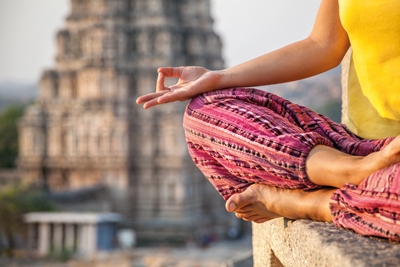 Woman doing meditation near Virupaksha temple in Hampi, Karnataka, India