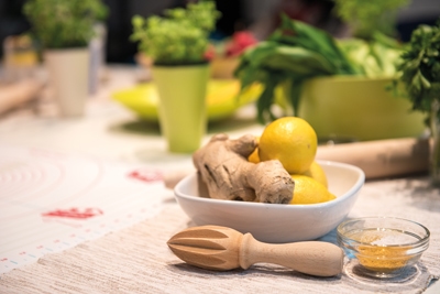 Ginger and lemon in bowl with turmeric ready for healthy beverage preparation