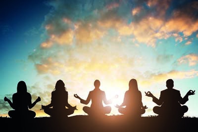 Silhouette Of People Doing Yoga Against Sky During Early Morning