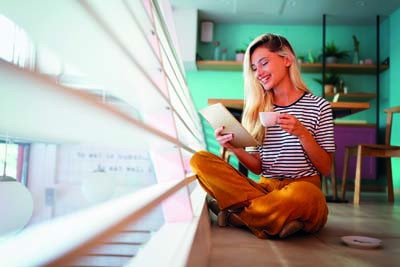 Portrait of pretty student or businesswoman in smart casual using digital tablet