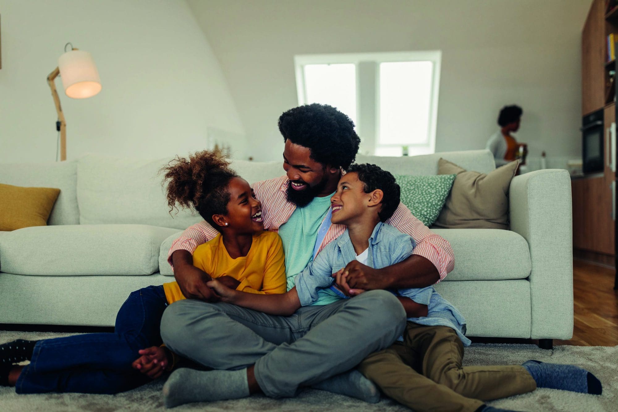 Afro father and children having fun at home