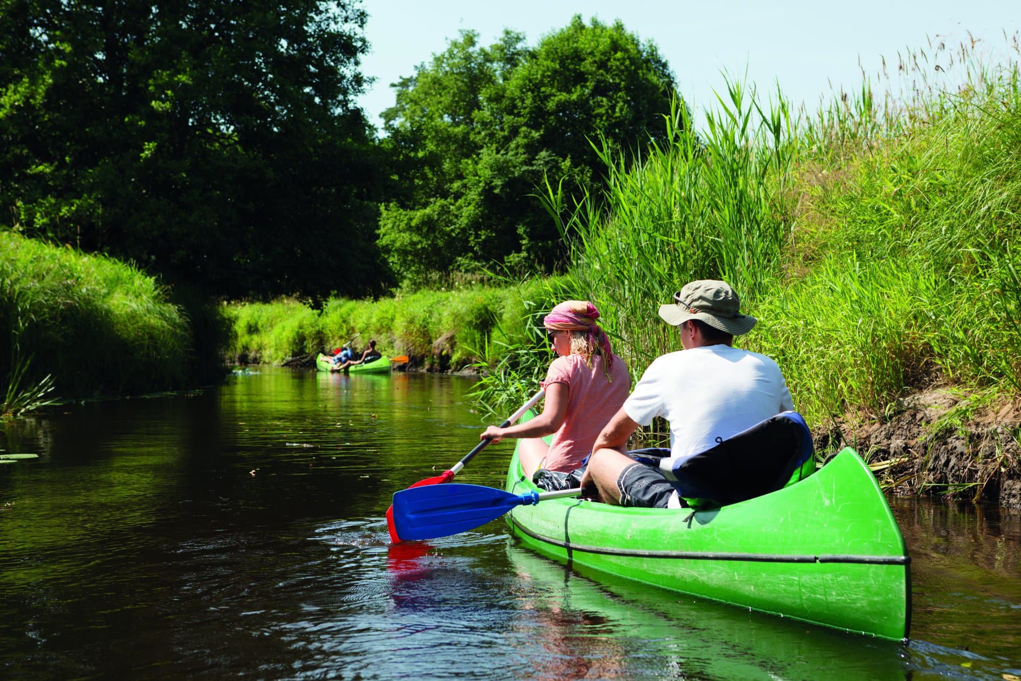 People boating on small river and having fun