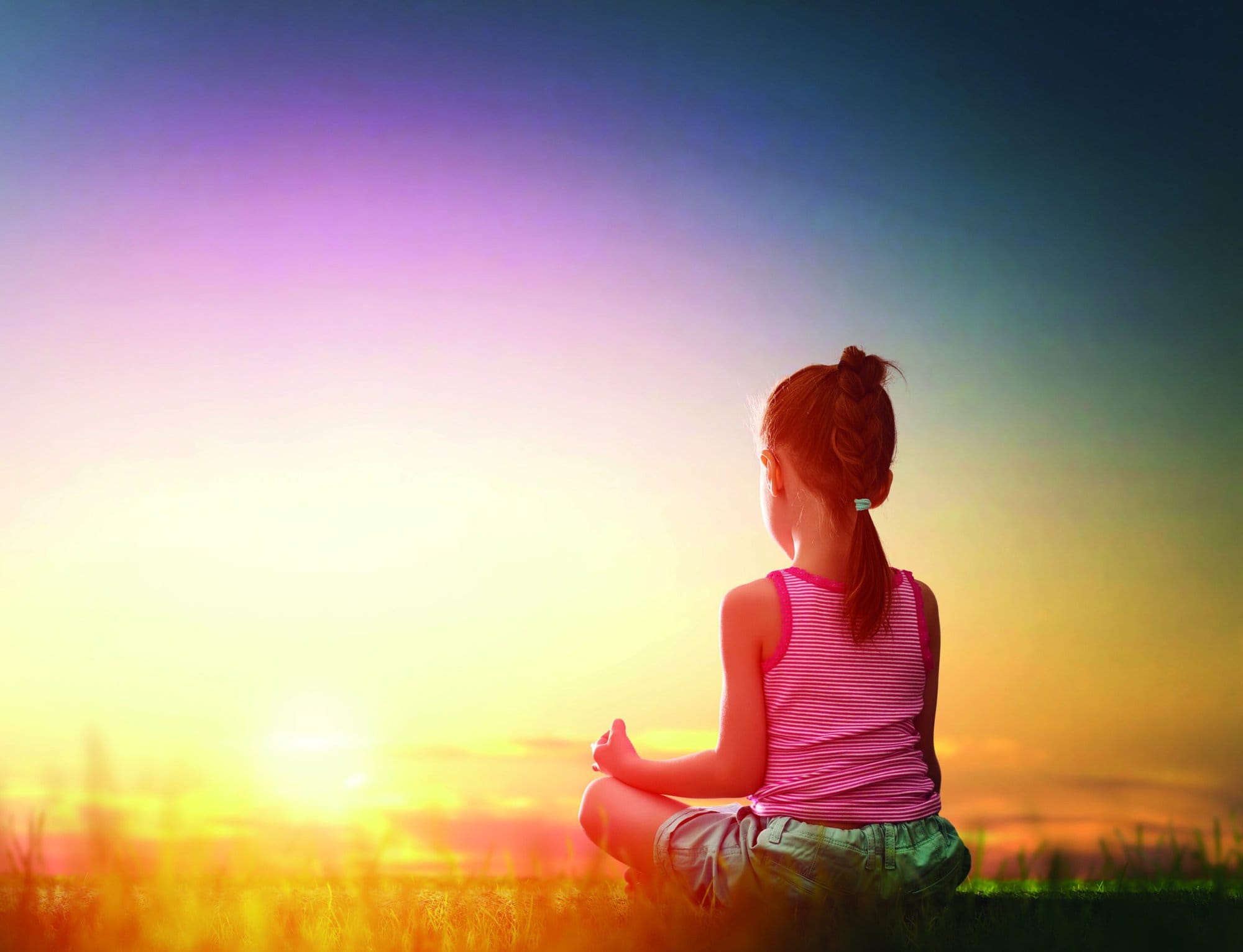 Child girl in the Park. Yoga at sunset in the park. Girl is practicing yoga.