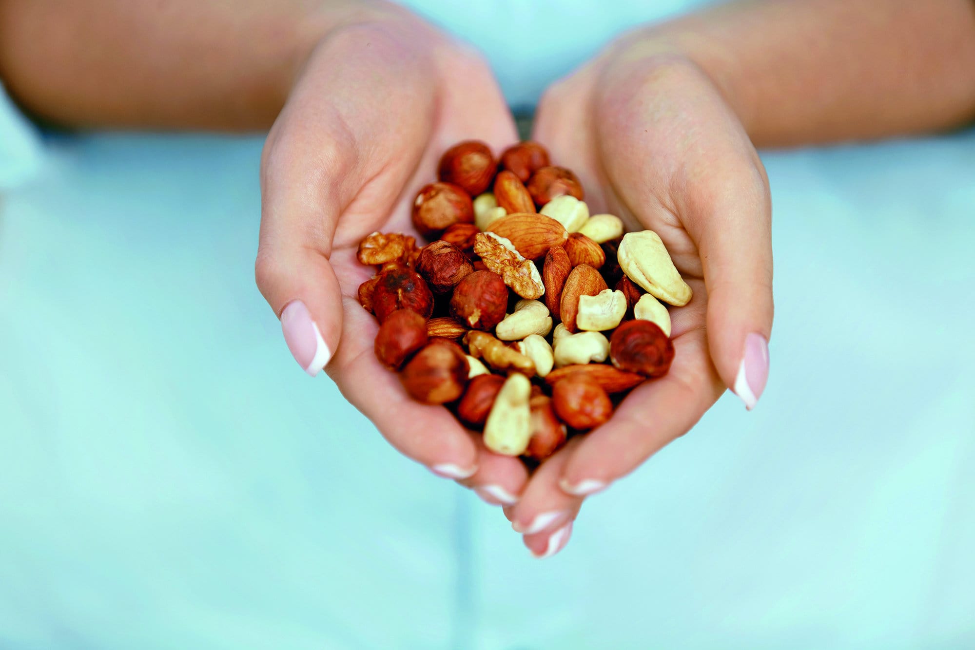 Nuts In Hands. Woman Hands Holding Healthy Food