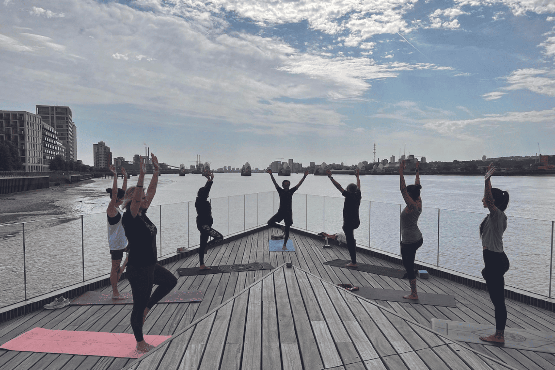 Peter Chung teaching at Pontoon Dock Pier by the Thames Barrier Yoga is for every body