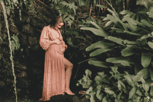 a pregnant woman in a peach dress