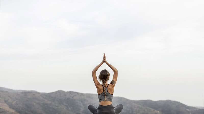 back-view-woman-doing-yoga-outdoors