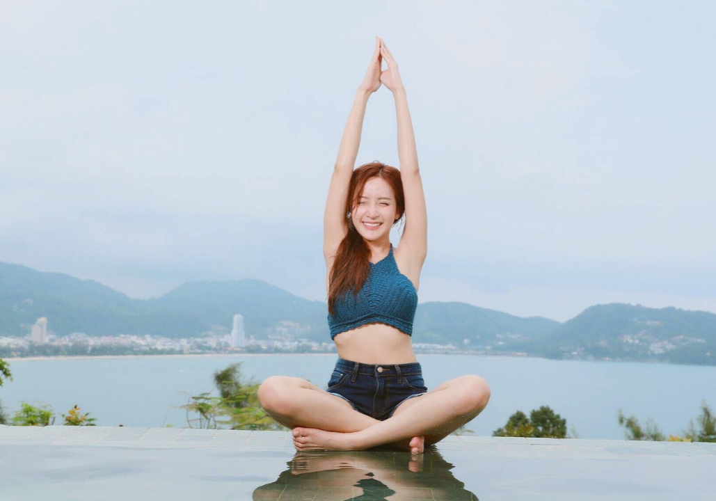 Woman Doing Yoga on Poolside