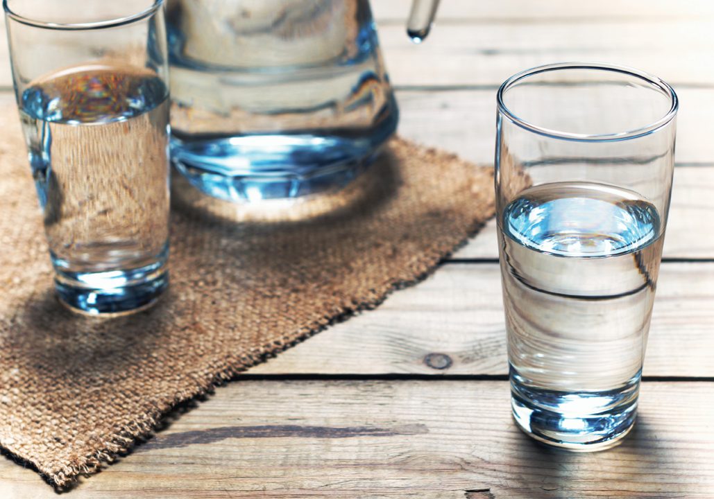Glasses,Of,Water,On,A,Wooden,Table.,Selective,Focus.,Shallow Glasses of water on a wooden table. Selective focus. Shallow DOF
