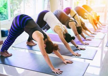 Women exercising in fitness studio yoga classes