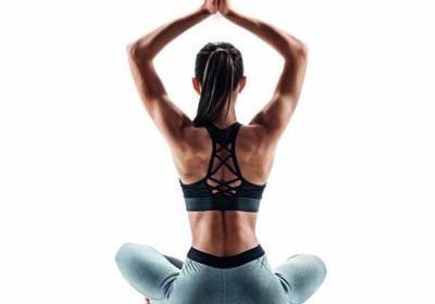 Young attractive girl practicing yoga isolated on white background. Concept of healthy life and natural balance between body and mental development. Full length