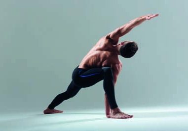 Handsome man doing yoga exercise isolated on a white background