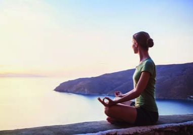 Young woman practicing yoga outdoors. Harmony and meditation concept. Healthy lifestyle