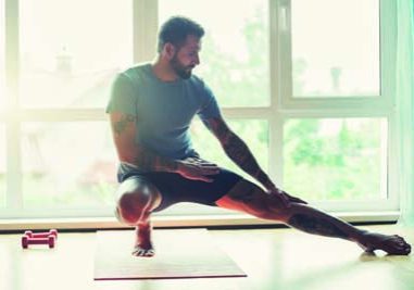 handsome sporty man doing exercise at home